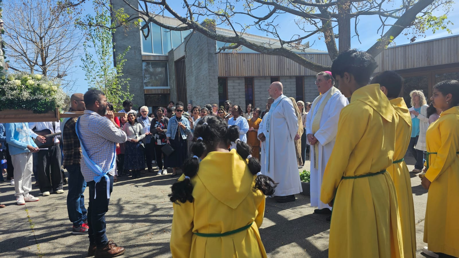 Wide shot of the community gathering